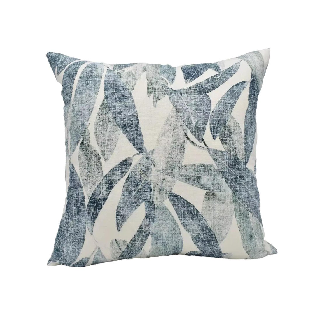 A square throw pillow with a blue and white leaf pattern is displayed against a white background.