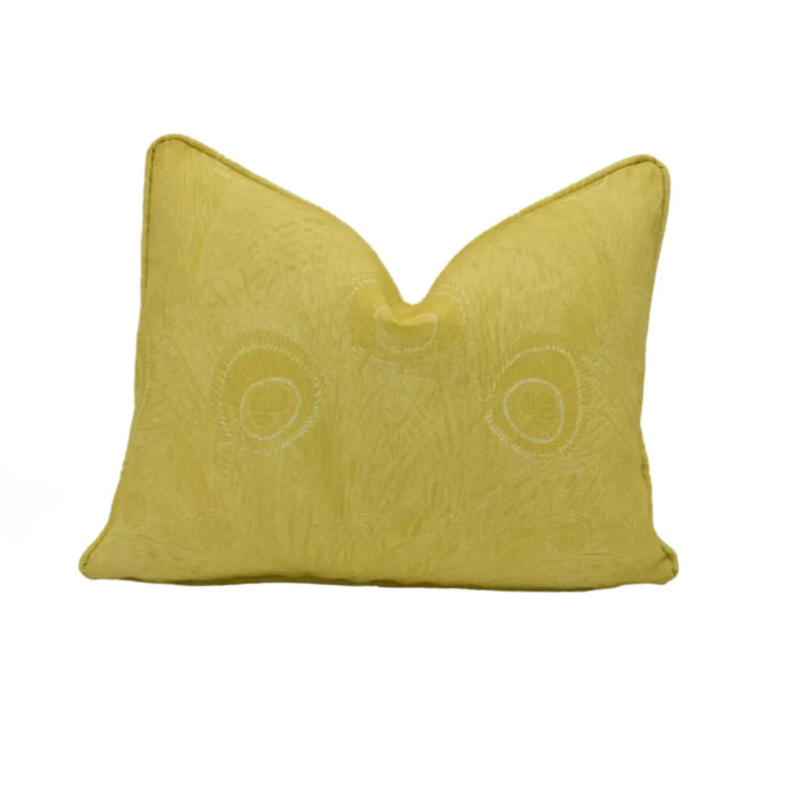 A yellow, textured pillow with a simple, clean design.