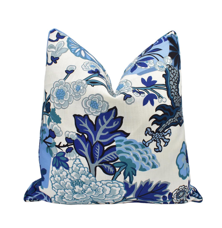 a blue and white pillow on a white background