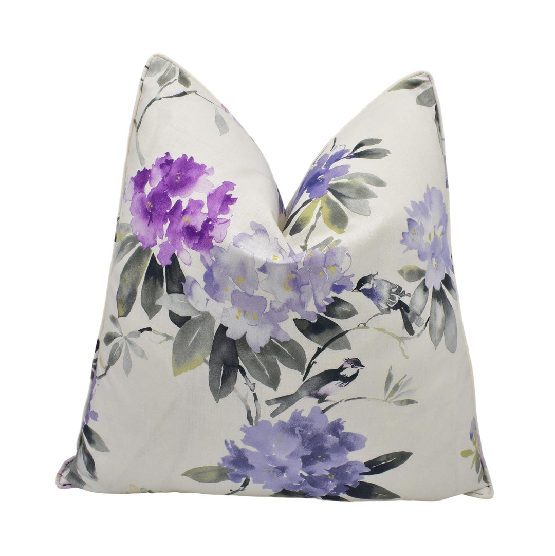 a white pillow with purple flowers on it