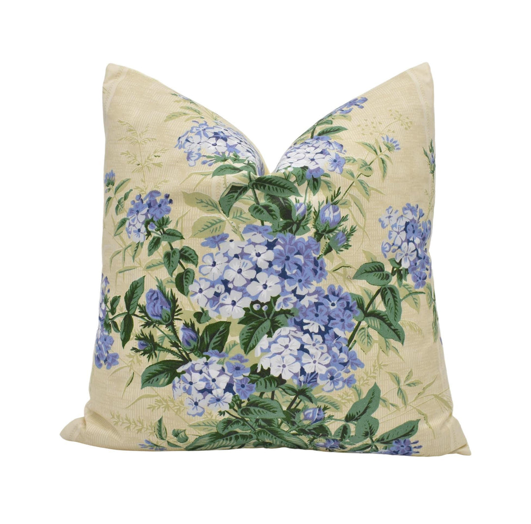 a yellow pillow with blue flowers on it