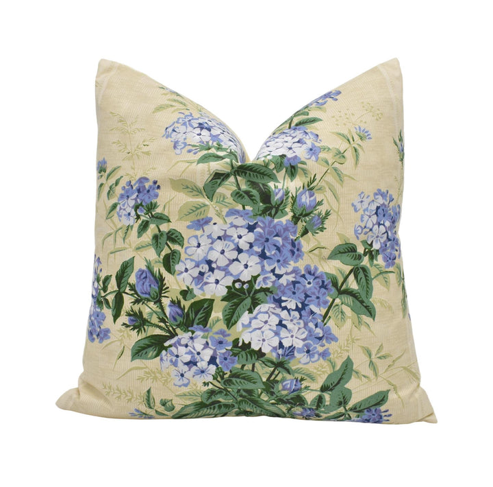 a yellow pillow with blue flowers on it