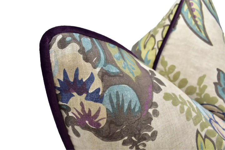 a close-up view of a decorative pillow with a floral pattern in shades of green, blue, and purple.