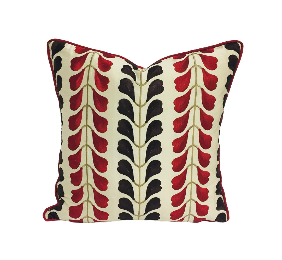 a red and black pillow on a white background