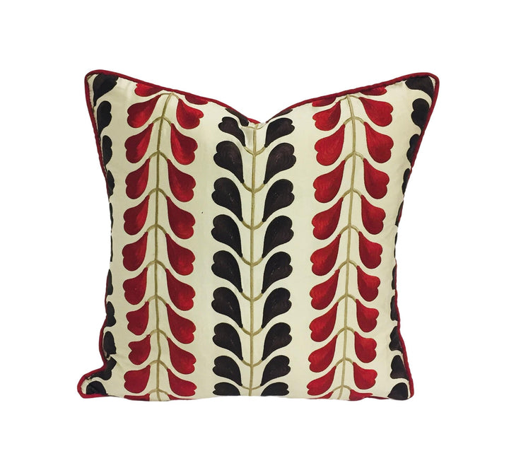 a red and black pillow on a white background