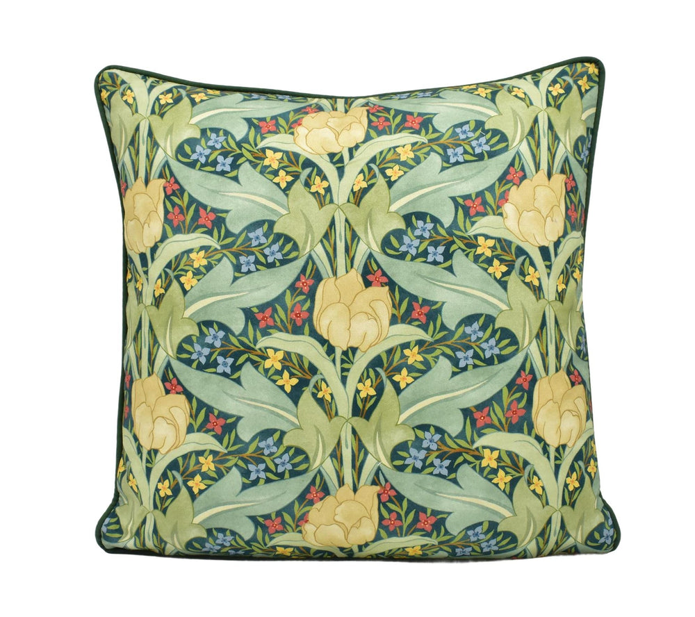 a green pillow with yellow and blue flowers on it