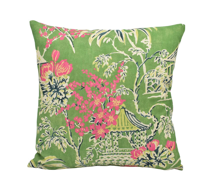 A square throw pillow with a vibrant green background and a floral pattern in shades of pink and yellow.