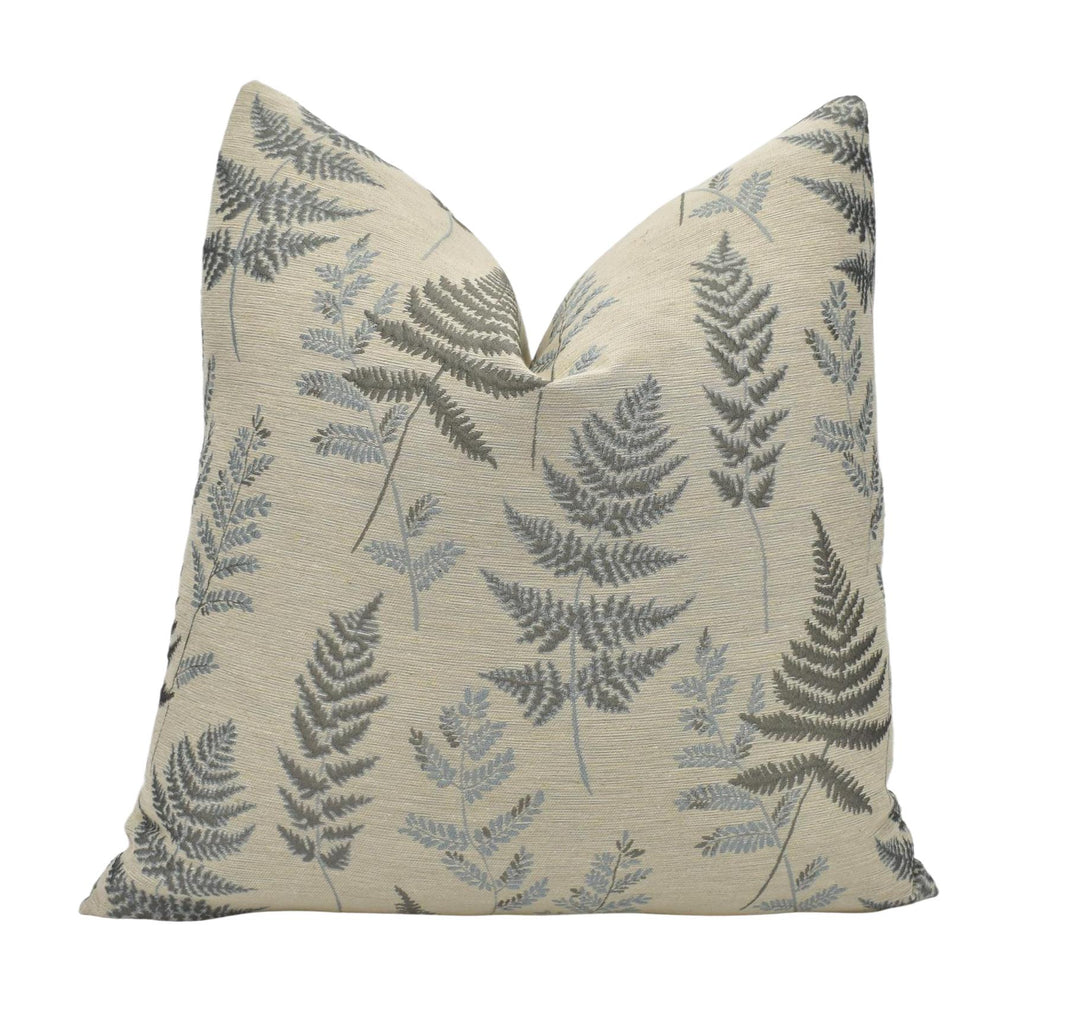 a pillow with a fern print on it