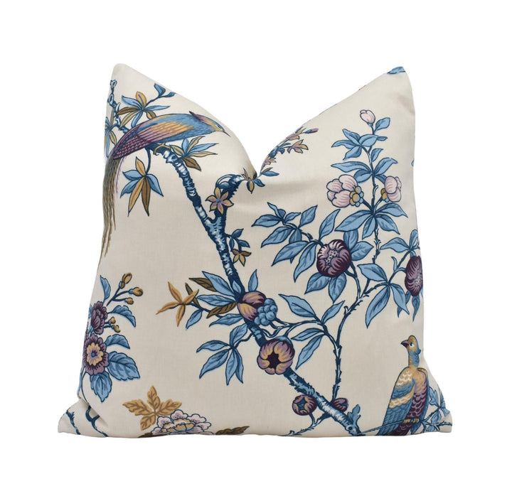 a blue and white pillow with a bird on it