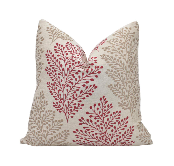 a red and white pillow with a leaf pattern