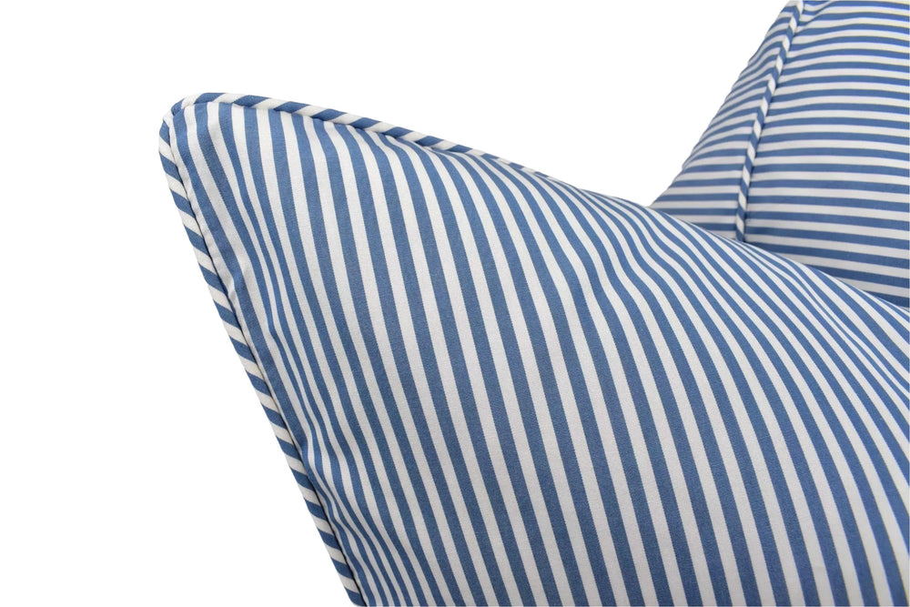 A close-up view of a blue and white striped pillow, with the pillow's edge and the fabric visible.