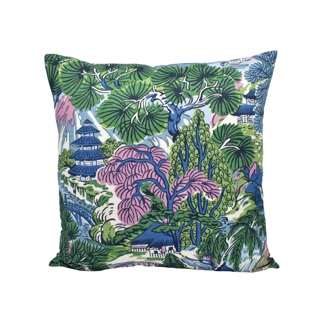 A colorful throw pillow with a tropical garden design, featuring various shades of green, pink, blue, and white.